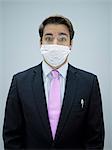 Businessman wearing swine flu mask