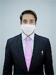 Businessman wearing swine flu mask