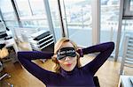 Woman with sleep mask, relaxing at office