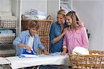 Woman ironing with her children