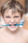 France, boy holding toothbrush