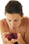 Portrait of a brown haired woman smelling dried flowers