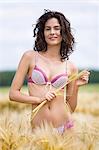 Young woman wearing underwear in wheat field