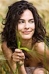 Young smiling woman holding wheat