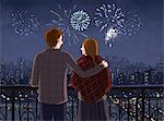 Couple watching firework display at night