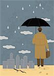 Businessman holding umbrella beside city