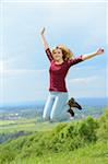 Young woman jumping in the air in spring, Germany