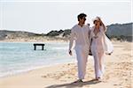 Young couple walking at the beach during summer holidays, Sardinia, Italy