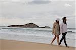 Young couple walking at the beach during a late summer afternoon holidays, Cala Cipolla, Chia Bay, Sardinia, Italy