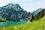 Mature man and woman looking at scenic view, Lake Vilsalpsee, Tannheim Valley, Austria