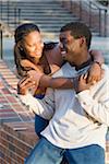 Young couple embracing outdoors on college campus, Florida, USA