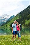 Portrait of mature couple hiking in mountains, Lake Vilsalpsee, Tannheim Valley, Austria