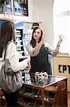 Shop assistant talking to customer in craft shop