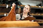 Worker looking at roll of leather