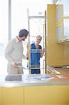 Young couple looking at storage in kitchen showroom