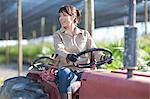 Woman on vehicle in plant nursery