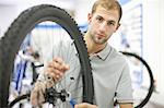 Young man working on bicycle