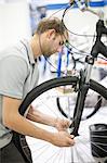 Young man working on bicycle