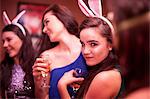 Young women wearing bunny ears at hen party