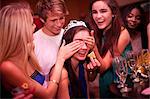 Young women playing drinking game at hen party