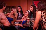 Young women watching male stripper at hen party