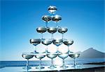 Champagne glasses in pyramid shape with sea in background