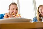 Young man eating pizza