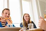 Young people eating pizza