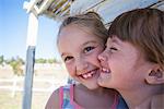 Portrait of two girls cheek to cheek smiling