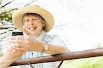Senior woman smiling at message on mobile phone