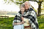 Senior couple wrapped in shawl together