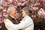 Husband and wife embracing in garden