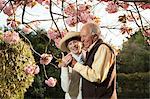 Senior couple smiling at message on mobile phone