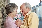 Man giving flower to wife