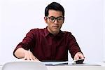 Young male designer looking at samples on desk