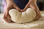 Close up of hands kneading bread dough