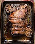 Cooked leg of lamb in roasting tin