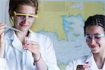 Close up of teenage girls with pipettes and test tube