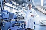 Portrait of lab technician holding empty glass jar