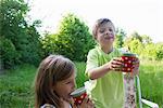 Brother and sister with picnic cups