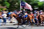 Woman on Horseback and Carrying American Flag in July 4th Parade, Alamosa, Colorado, USA.