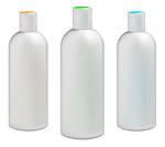 White plastic bottles for cosmetic creams, lotions, shampoo and gels with colored caps