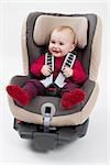 booster seat with child for a car in light background. studio shot