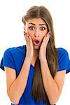 Beautiful long-haired young lady looking shocked at the camera while holding her hands on both sides of her face over white background.