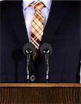 Presentation speech at a podium with microphones