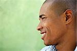 Portrait of happy young african american man looking away and smiling. Head and shoulders, copy space