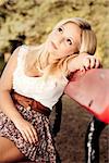 Beautiful young woman sitting on a park bench  and thinking on something