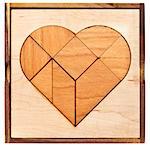 heart version of tangram, a traditional Chinese Puzzle Game made of different wood parts to build abstract figures from them, isolated on white