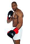 Strong african male boxer wearing black boxing gloves looking at you