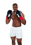 African boxer wearing boxing gloves ready to punch you